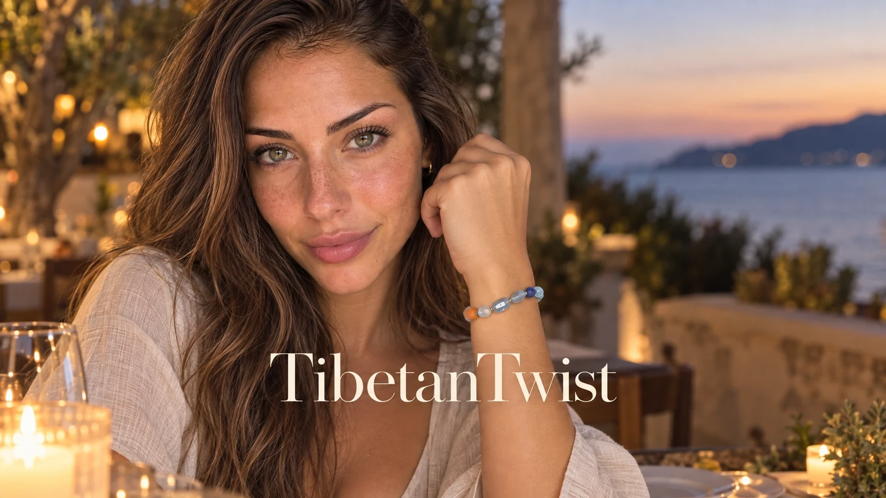 TibetanTwist Pure Serenity Irregular Crystal Bracelet – Aquamarine & Lapis Lazuli on a jewelry stand set on a travertine ledge before draped silk